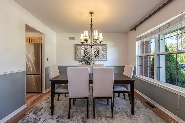 1953 Harley Ct, Ann Arbor, MI 48103 - dining area with a chandelier, light wood-style flooring, and baseboards