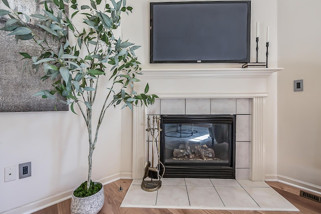 1953 Harley Ct, Ann Arbor, MI 48103 - detailed view of wood finished floors, a tiled fireplace, and baseboards