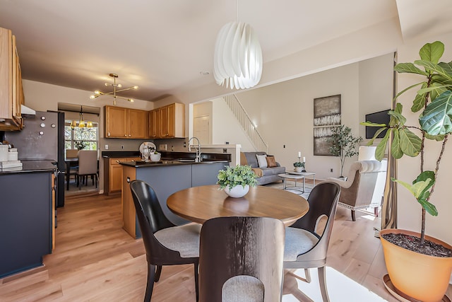 1953 Harley Ct, Ann Arbor, MI 48103 - dining area featuring light wood-type flooring, a chandelier, and stairway