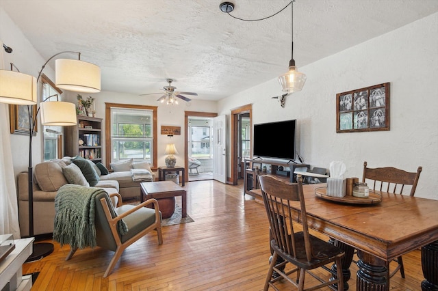 1000 W Ganson St, Jackson, MI 49202 - dining room featuring a textured ceiling, a ceiling fan, a textured wall, and light wood finished floors