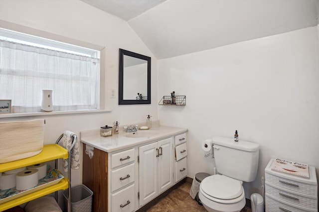 1000 W Ganson St, Jackson, MI 49202 - half bathroom featuring lofted ceiling, toilet, and vanity