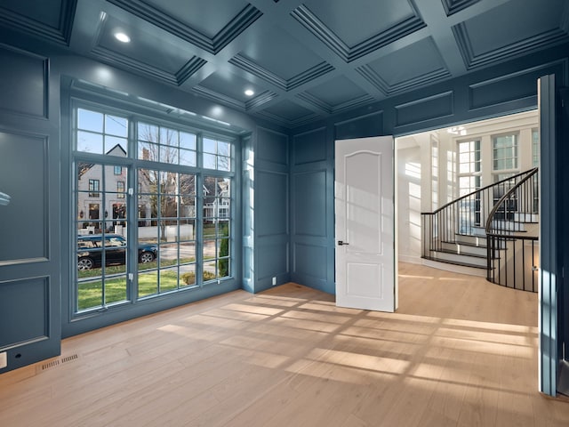 330 Ferndale Ave, Birmingham, MI 48009 - empty room featuring a decorative wall, light wood-type flooring, recessed lighting, coffered ceiling, and stairs