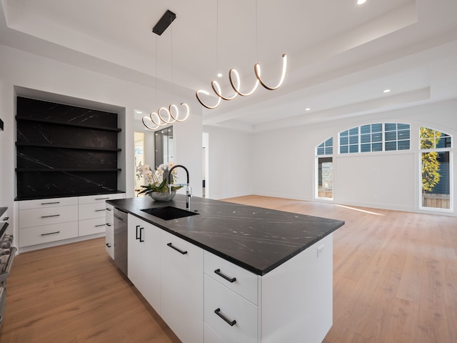 330 Ferndale Ave, Birmingham, MI 48009 - kitchen with a sink, a raised ceiling, modern cabinets, light wood-type flooring, and a center island with sink