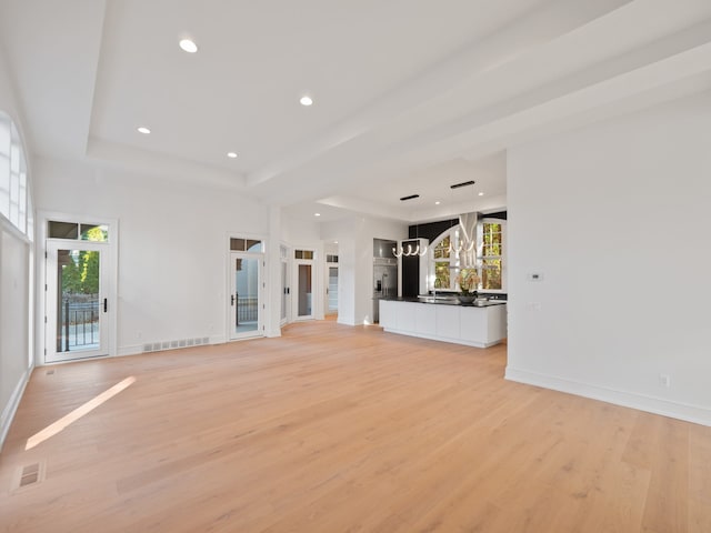 330 Ferndale Ave, Birmingham, MI 48009 - unfurnished living room with light wood finished floors, a chandelier, a raised ceiling, recessed lighting, and baseboards