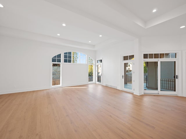 330 Ferndale Ave, Birmingham, MI 48009 - unfurnished living room with light wood-style floors, a raised ceiling, recessed lighting, and baseboards
