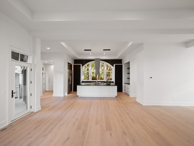 330 Ferndale Ave, Birmingham, MI 48009 - unfurnished living room featuring a raised ceiling, light wood-type flooring, baseboards, and recessed lighting
