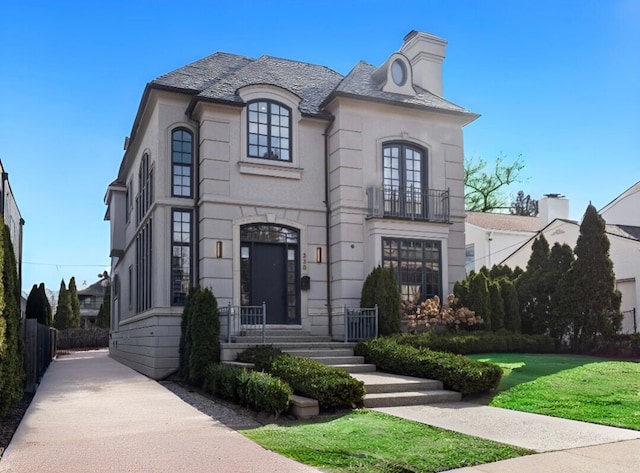 330 Ferndale Ave, Birmingham, MI 48009 - french country inspired facade featuring a front lawn, a balcony, a high end roof, and a chimney