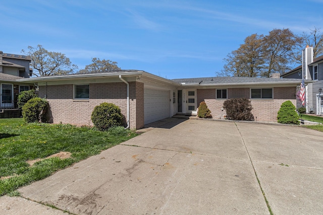 7262 Hatchery Rd, Waterford, MI 48327 - view of front of house featuring an attached garage, brick siding, and concrete driveway