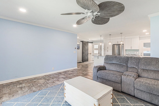 7262 Hatchery Rd, Waterford, MI 48327 - living area with a barn door, recessed lighting, a ceiling fan, crown molding, and wood finished floors