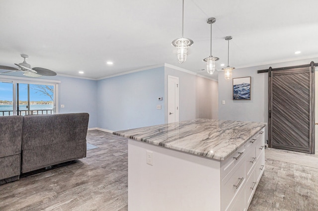 7262 Hatchery Rd, Waterford, MI 48327 - kitchen featuring light wood-style flooring, a ceiling fan, recessed lighting, white cabinets, and a kitchen island