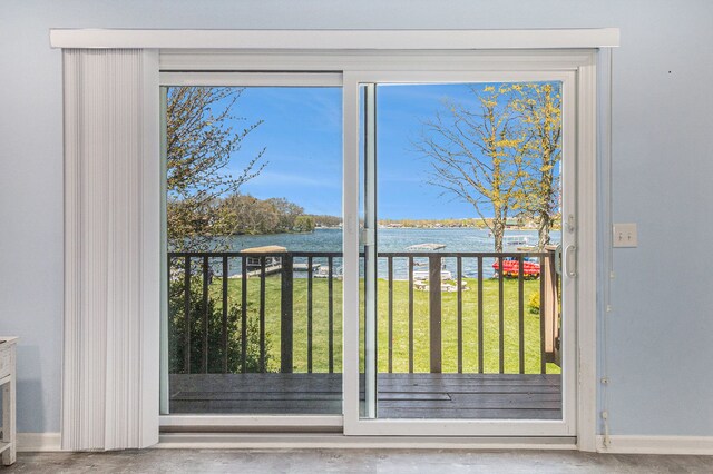 7262 Hatchery Rd, Waterford, MI 48327 - doorway to outside with a water view, baseboards, concrete floors, and healthy amount of natural light