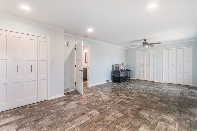 7262 Hatchery Rd, Waterford, MI 48327 - unfurnished bedroom featuring two closets, wood finished floors, baseboards, ornamental molding, and ceiling fan