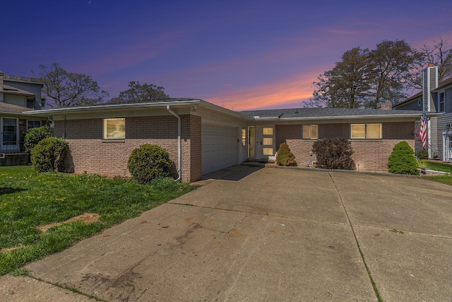 7262 Hatchery Rd, Waterford, MI 48327 - view of front of property with an attached garage, brick siding, driveway, and a lawn