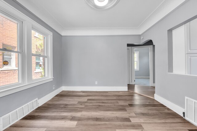 15430 Mendota St, Detroit, MI 48238 - empty room with plenty of natural light, arched walkways, and wood finished floors