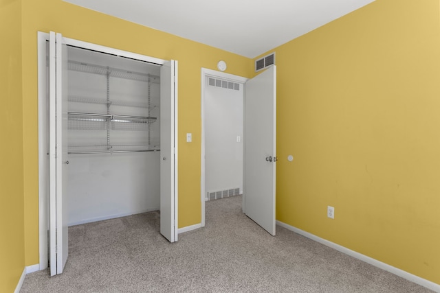 unfurnished bedroom with carpet floors, a closet, and baseboards
