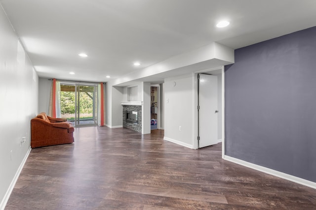 unfurnished living room featuring a fireplace, baseboards, dark wood-style floors, and recessed lighting
