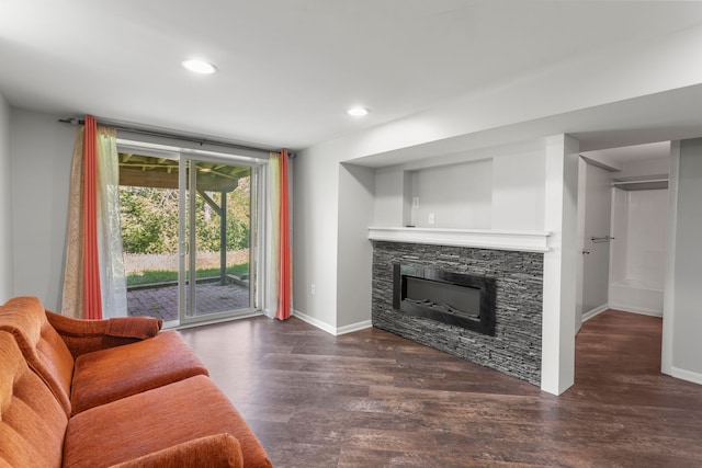living room with baseboards, a fireplace, wood finished floors, and recessed lighting