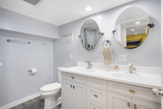 68687 M-43, South Haven, MI 49090 - full bath featuring toilet, double vanity, wood finished floors, baseboards, and recessed lighting