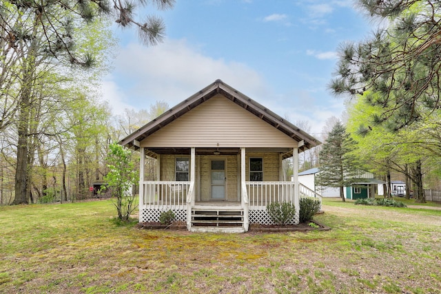 68687 M-43, South Haven, MI 49090 - view of front of home featuring covered porch, a front yard, and an outdoor structure