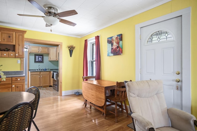 68687 M-43, South Haven, MI 49090 - dining space with crown molding, light wood-style floors, ceiling fan, and baseboards