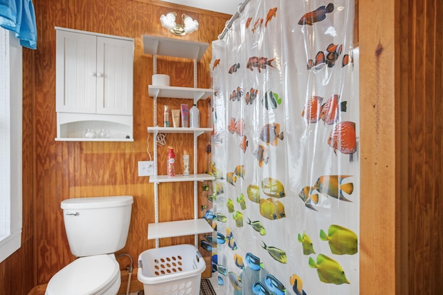 68687 M-43, South Haven, MI 49090 - bathroom featuring toilet, a shower with curtain, and wood walls