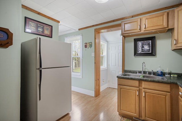 68687 M-43, South Haven, MI 49090 - kitchen featuring freestanding refrigerator, a sink, light wood-style flooring, dark countertops, and baseboards