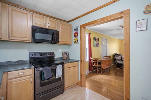 68687 M-43, South Haven, MI 49090 - kitchen featuring black microwave, stainless steel range with electric cooktop, light brown cabinets, dark countertops, and ornamental molding