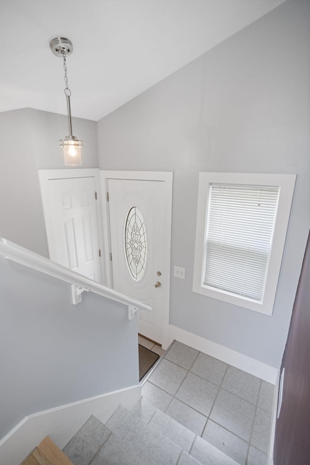 68687 M-43, South Haven, MI 49090 - foyer with baseboards, tile patterned flooring, vaulted ceiling, and stairway