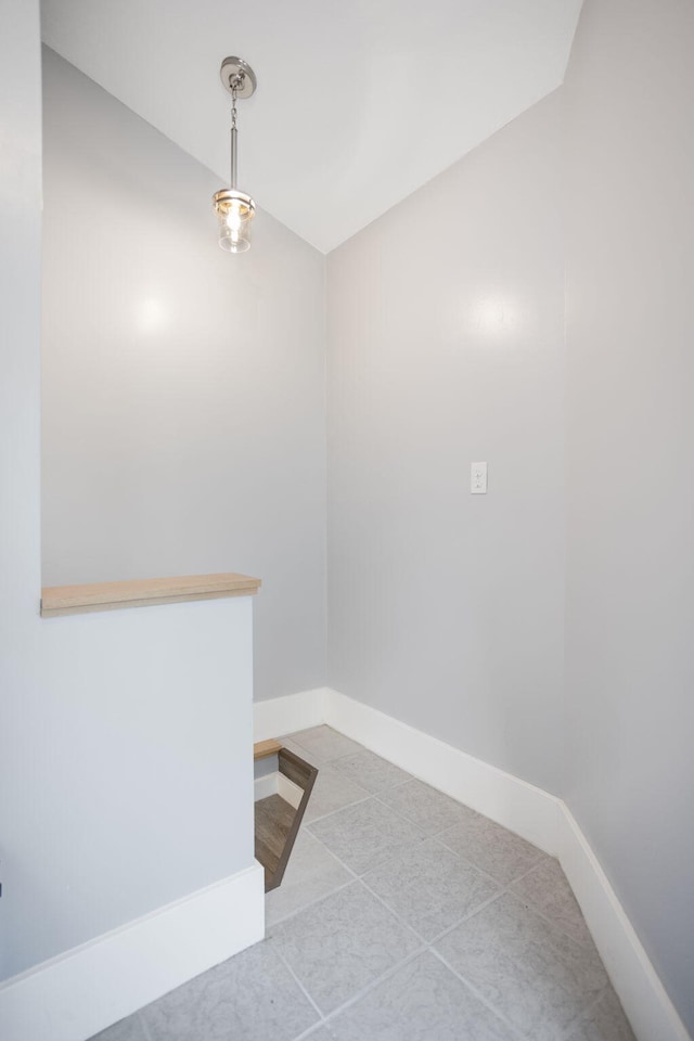 68687 M-43, South Haven, MI 49090 - unfurnished dining area with vaulted ceiling, baseboards, and tile patterned flooring