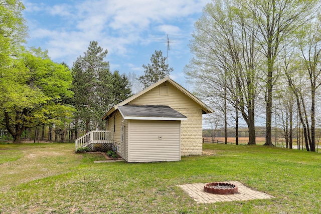 68687 M-43, South Haven, MI 49090 - rear view of property with a lawn, an outdoor fire pit, and an outdoor structure