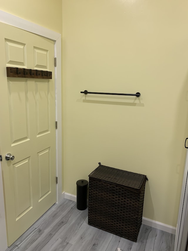 bathroom featuring wood finished floors and baseboards