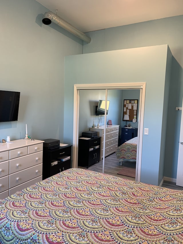 bedroom with a closet and wood finished floors