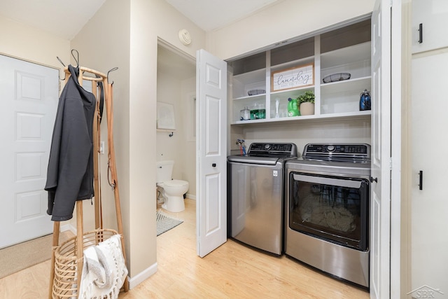 1961 Seminole Ln, Saginaw, MI 48638 - washroom featuring washer and clothes dryer and light wood-style flooring