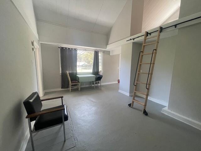 519 Whaley St, Cadillac, MI 49601 - dining area with concrete flooring, baseboards, and lofted ceiling