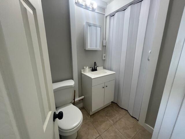 519 Whaley St, Cadillac, MI 49601 - bathroom featuring toilet, vanity, and tile patterned flooring