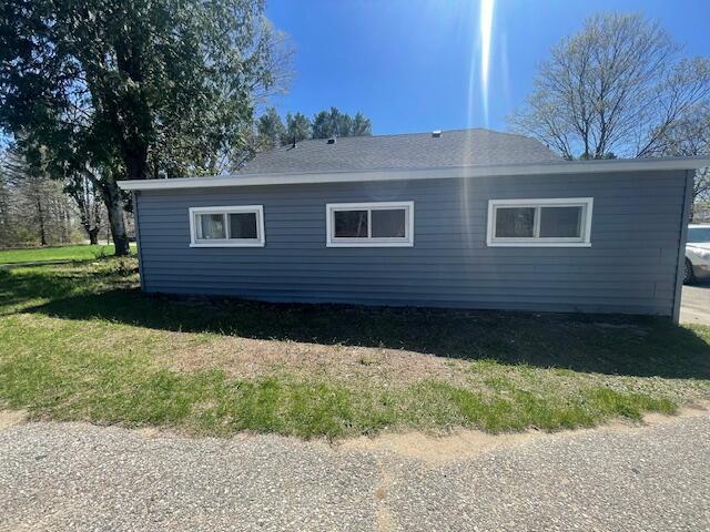 519 Whaley St, Cadillac, MI 49601 - view of home's exterior with a lawn