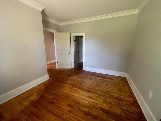 519 Whaley St, Cadillac, MI 49601 - spare room featuring crown molding, wood finished floors, and baseboards