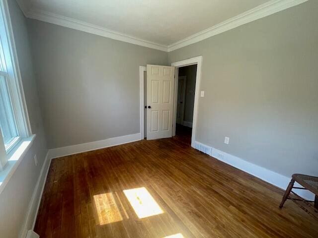 519 Whaley St, Cadillac, MI 49601 - spare room featuring wood finished floors, crown molding, and baseboards