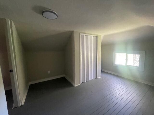 519 Whaley St, Cadillac, MI 49601 - additional living space with lofted ceiling, dark wood finished floors, and baseboards