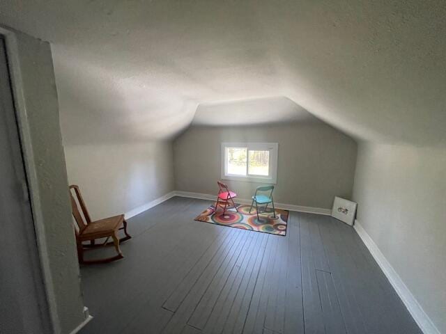 519 Whaley St, Cadillac, MI 49601 - bonus room featuring lofted ceiling, wood-type flooring, and baseboards