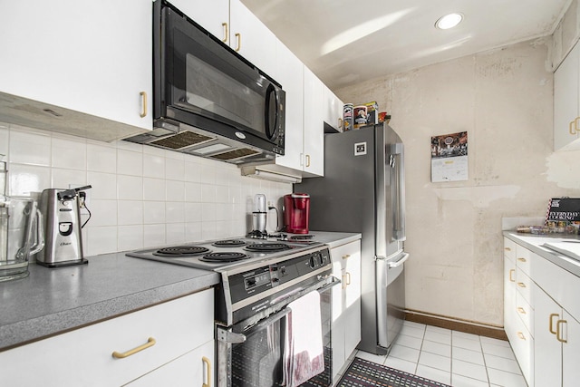 409 Lake Dr Unit 10, New Buffalo, MI 49117 - kitchen featuring electric range oven, black microwave, tasteful backsplash, white cabinets, and light tile patterned floors