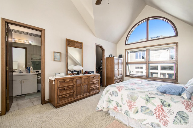 409 Lake Dr Unit 10, New Buffalo, MI 49117 - bedroom featuring light carpet, high vaulted ceiling, a sink, and ensuite bath