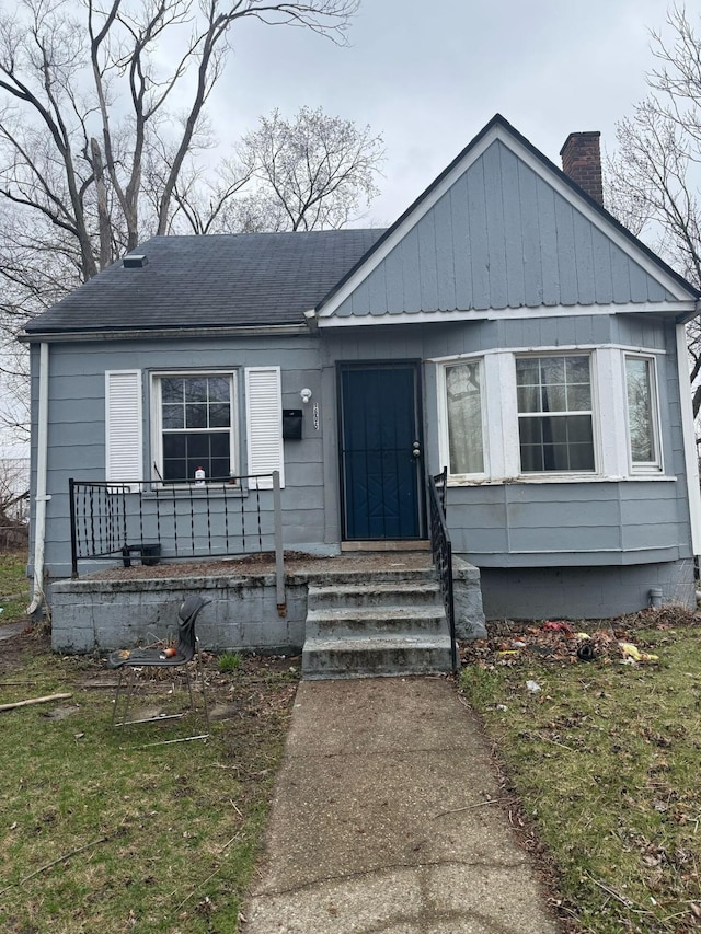 9605 Decatur St, Detroit, MI 48227 - bungalow-style house featuring a chimney, a shingled roof, and covered porch