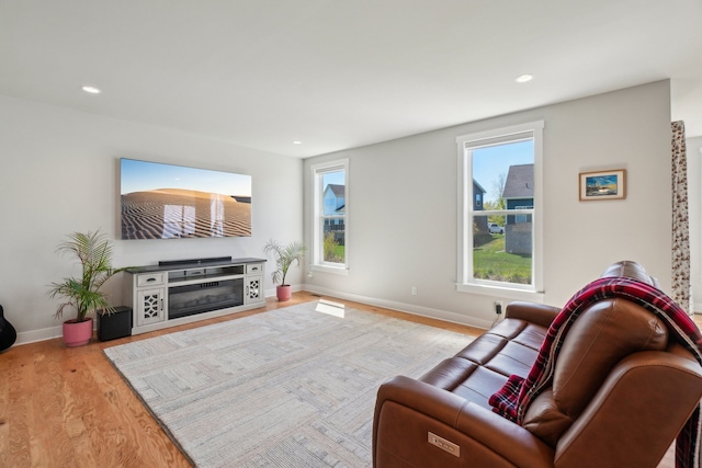 5534 Helmsdale Blvd, West Bloomfield, MI 48322 - living area featuring wood finished floors, baseboards, recessed lighting, and a glass covered fireplace