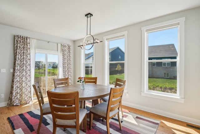 5534 Helmsdale Blvd, West Bloomfield, MI 48322 - dining room with healthy amount of natural light, baseboards, a chandelier, and light wood-style floors