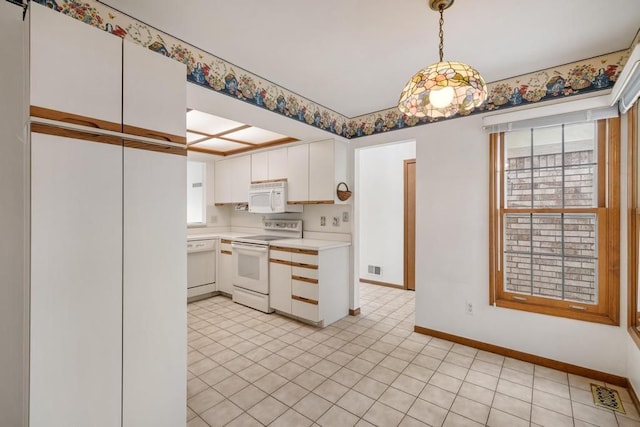 43389 Riverbend Blvd, Clinton Township, MI 48038 - kitchen featuring white appliances, light countertops, baseboards, white cabinetry, and pendant lighting
