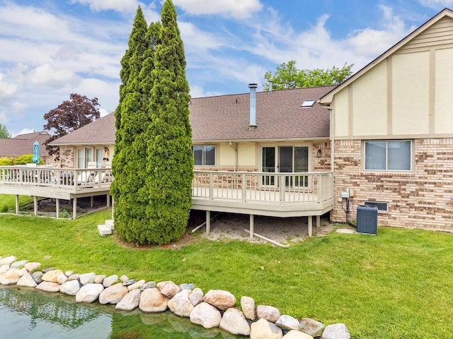 43389 Riverbend Blvd, Clinton Township, MI 48038 - back of property featuring a wooden deck, a lawn, brick siding, central air condition unit, and roof with shingles