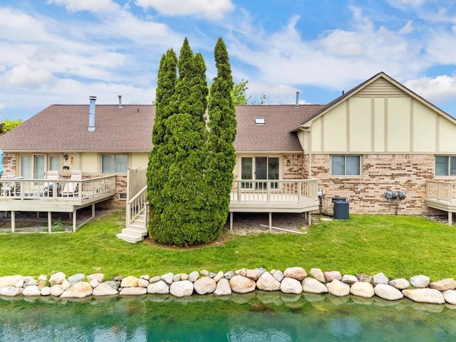 43389 Riverbend Blvd, Clinton Township, MI 48038 - rear view of property featuring a deck with water view, a lawn, and a shingled roof