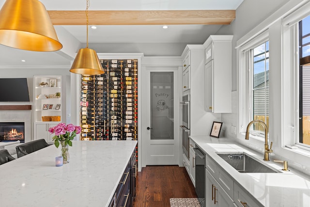 wine area with a sink, dark wood-type flooring, recessed lighting, a premium fireplace, and beamed ceiling