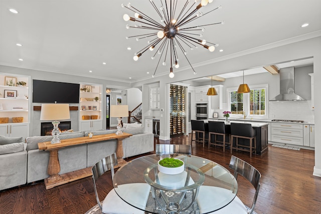dining area with stairway, a lit fireplace, recessed lighting, dark wood finished floors, and a chandelier